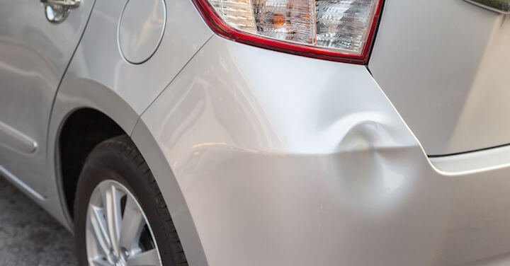 Small dent in the rear fender of a car