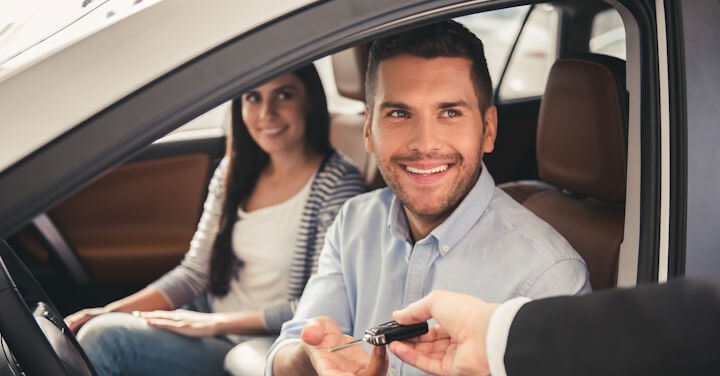 Young couple in their new car