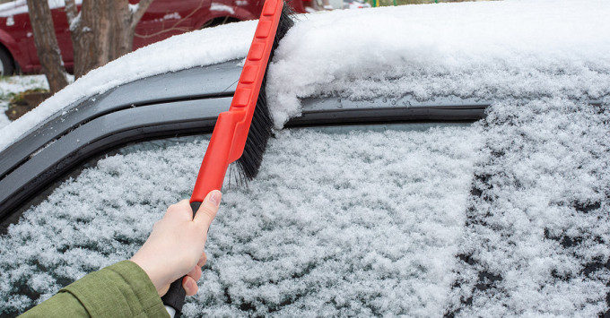 Clearing snow from windshield
